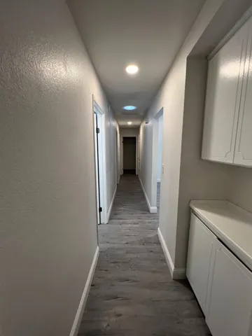 a view of hallway with wooden floor