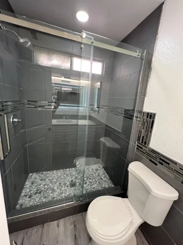 a bathroom with a toilet and shower