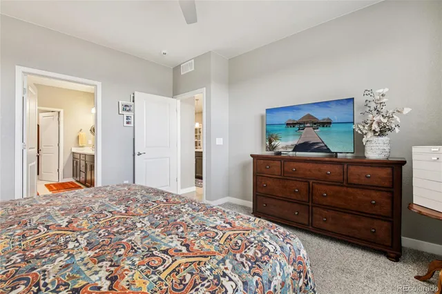 a bedroom with a bed and a dresser in it