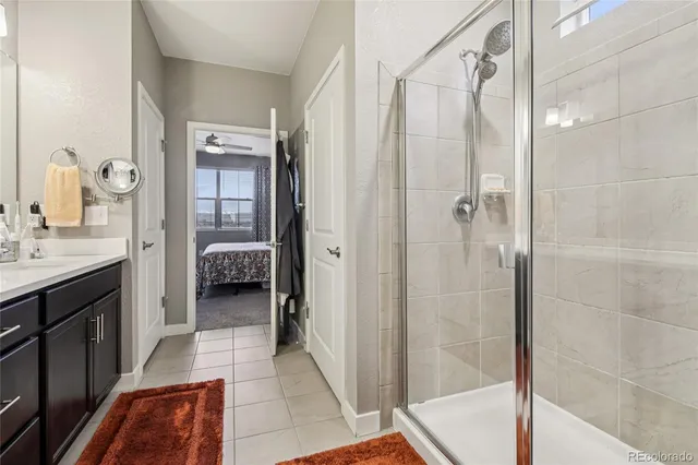 a en suite bathroom with a shower and a sink