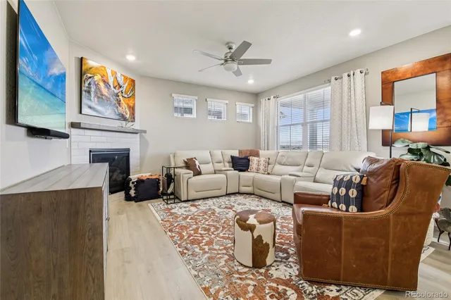a living room with fireplace furniture and a flat screen tv