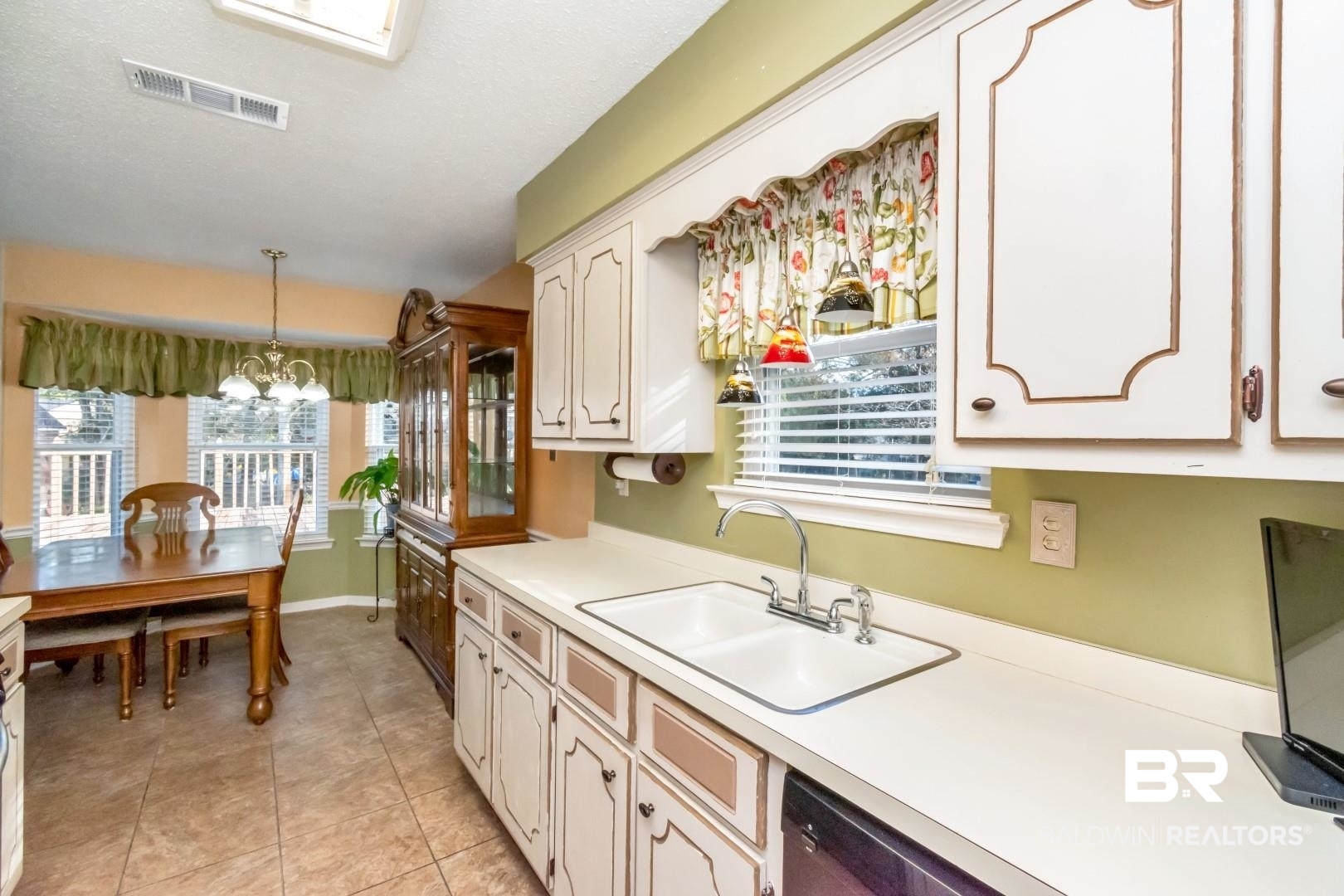 9360 Burnt Tree Drive Mobile, AL 36695 - Photo 11 of 28 Kitchen with sink, a healthy amount of sunlight, decorative light fixtures, and an inviting chandelier