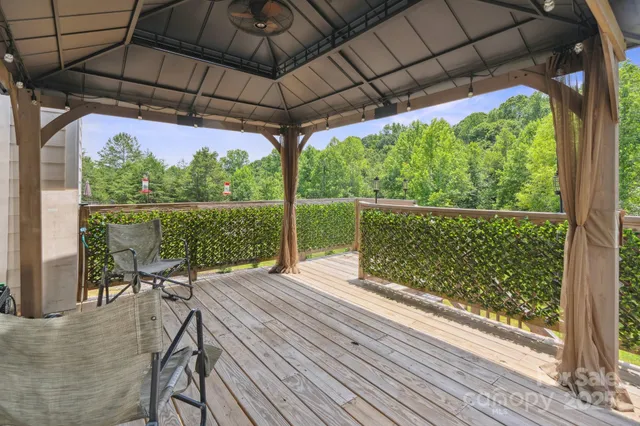 a view of a patio with table and chairs under an umbrella