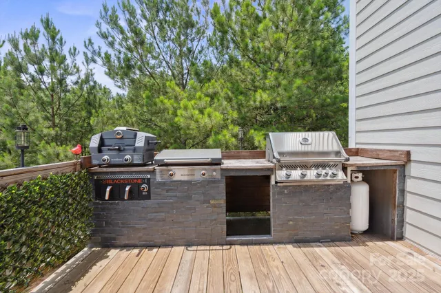 a view of a deck with wooden floor and yard