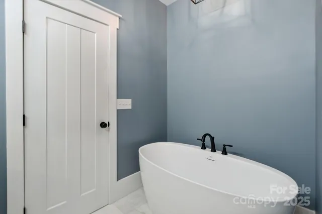 a white bath tub sitting next to a white sink