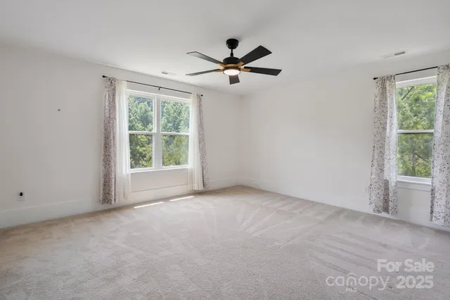 a bedroom with a large bed couch and a window