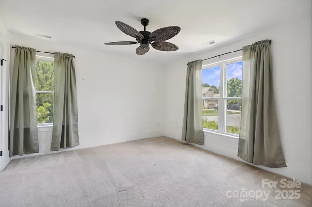a bathroom with a granite countertop sink a toilet a mirror a vanity and shower
