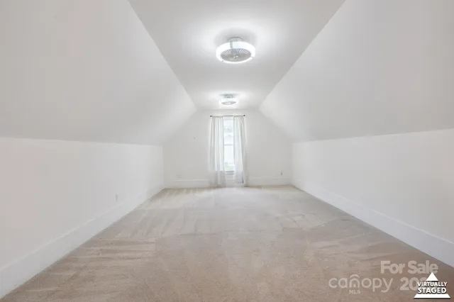 an empty room with a fireplace and lots of wooden floor
