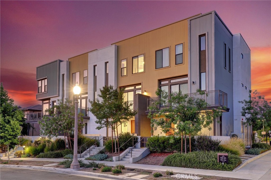 a front view of multi story residential apartment building with yard