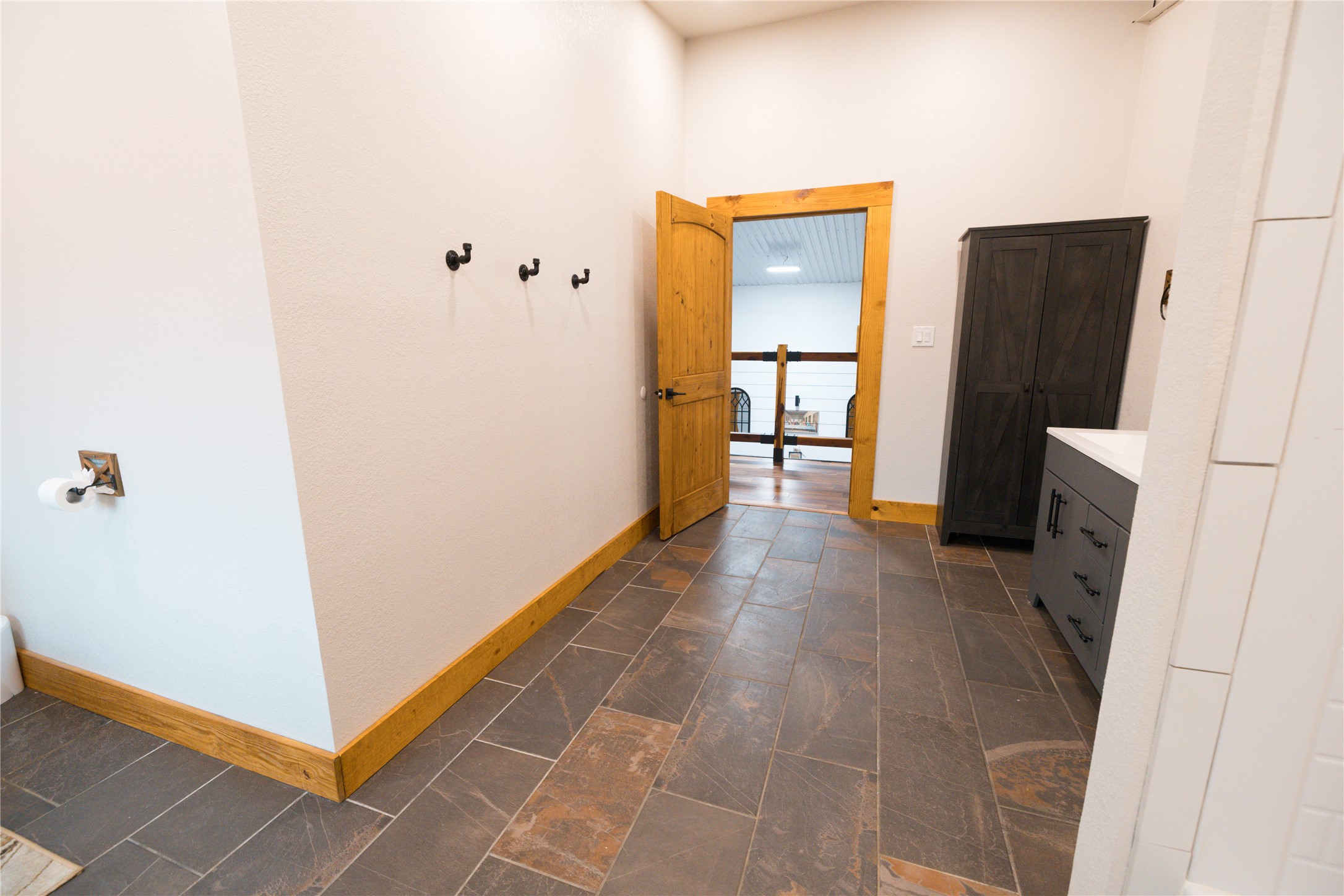 143 County Road Paige, TX 78659 - Photo 15 of 36 View of Hallway featuring baseboards in upstairs bathroom