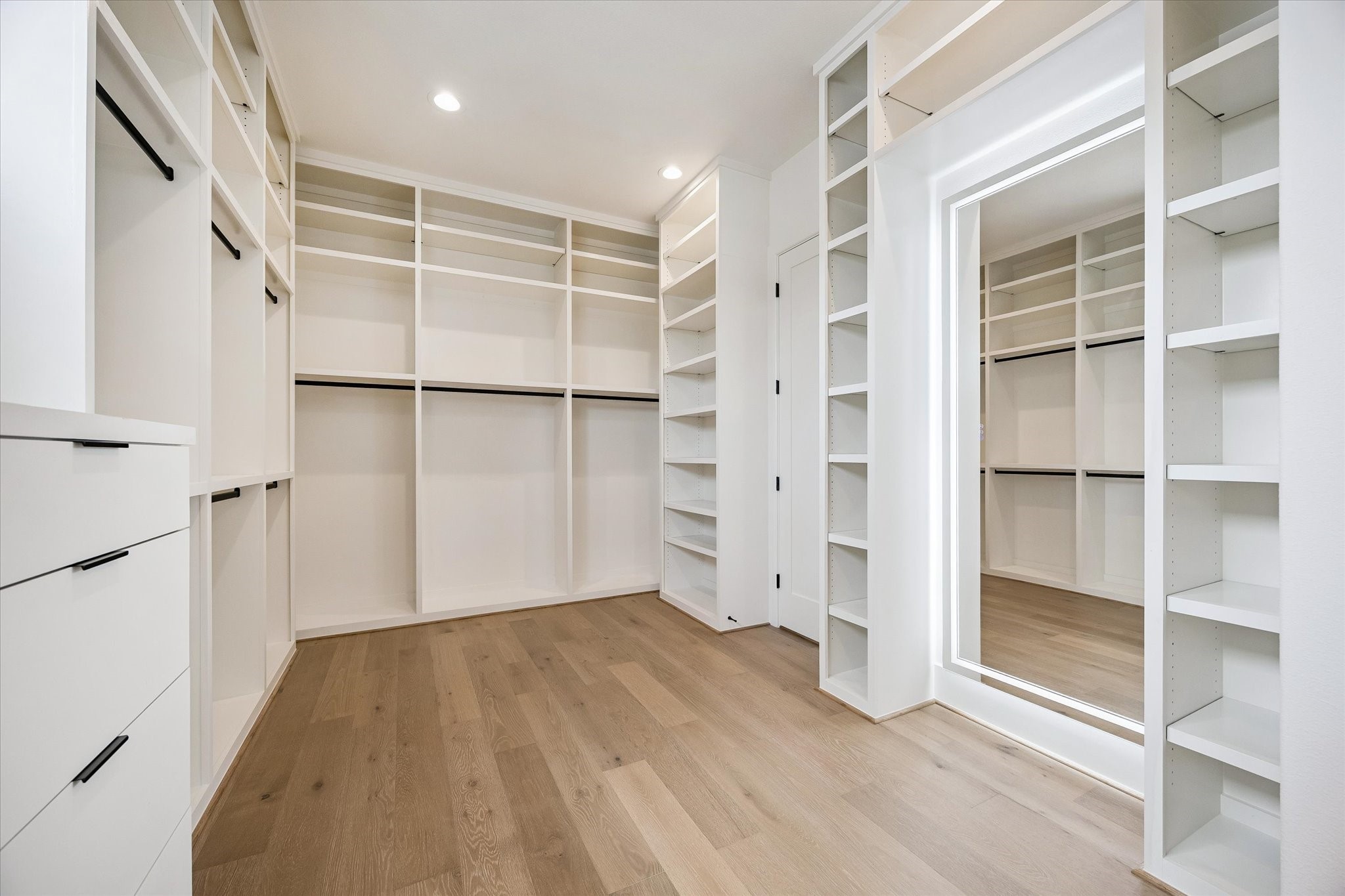 335 Harvard Street Houston, TX 77007 - Photo 19 of 35 Spacious walk-in primary closet wth custom built-ins and a full length mirror.