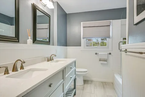 a bathroom with a sink toilet and mirror