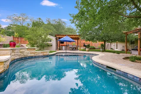 a view of a swimming pool with a patio