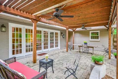 a view of a patio with table and chairs and potted plants