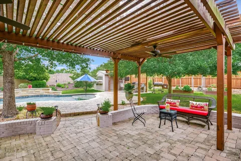 a garden with trees in the back