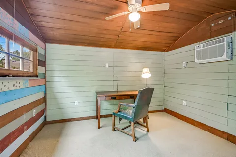 a bench sitting in a room next to a window