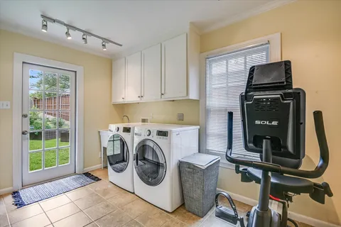 a utility room with dryer washer and a window