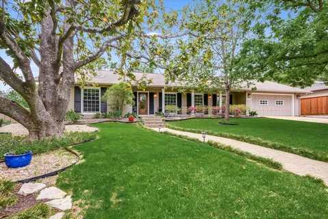 a front view of a house with a yard table and chairs