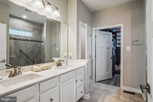 a bathroom with double sink and a mirror