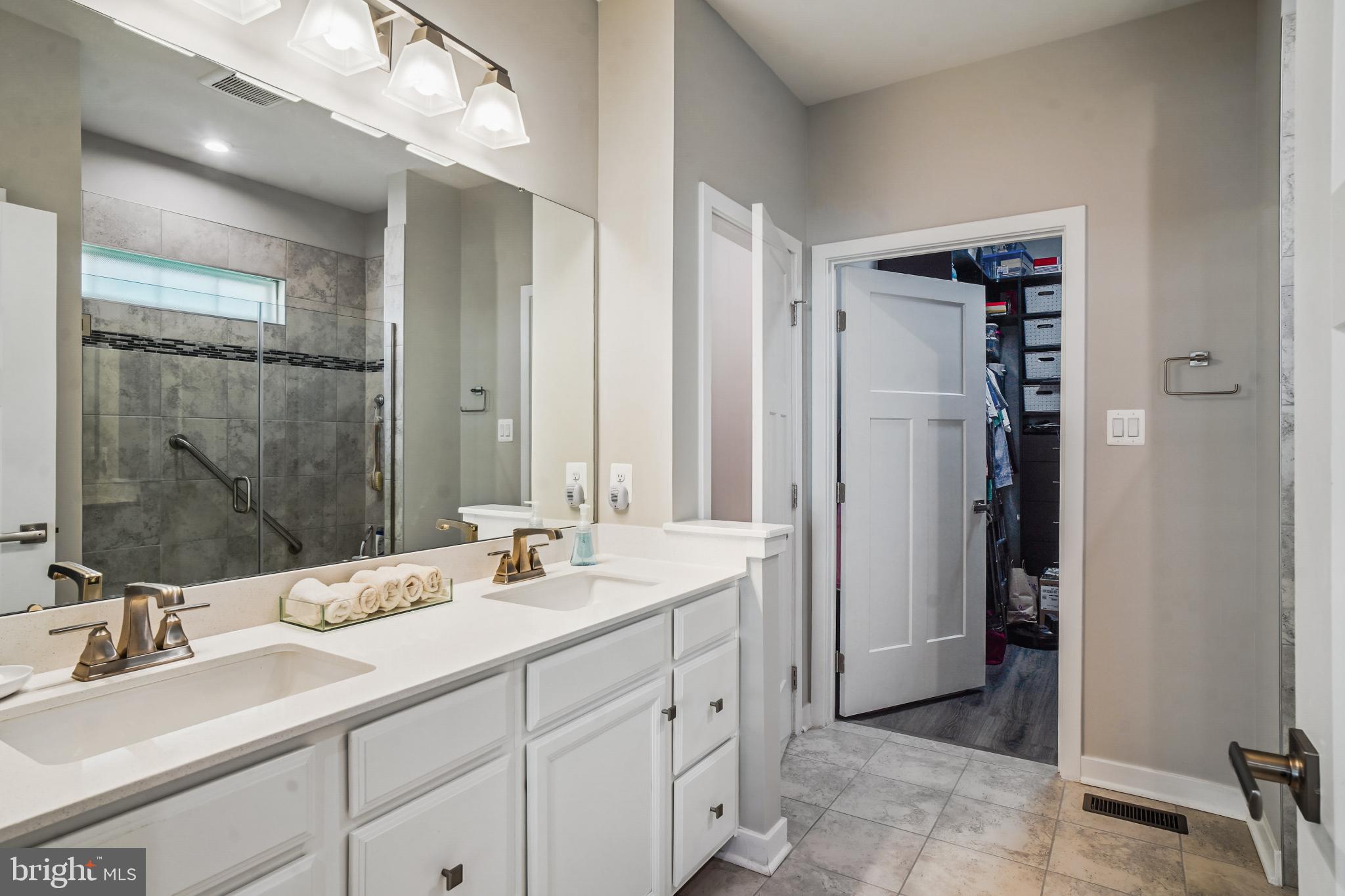 6126 Dock Street Frederick, MD 21703 - Photo 14 of 30 a bathroom with double sink and a mirror