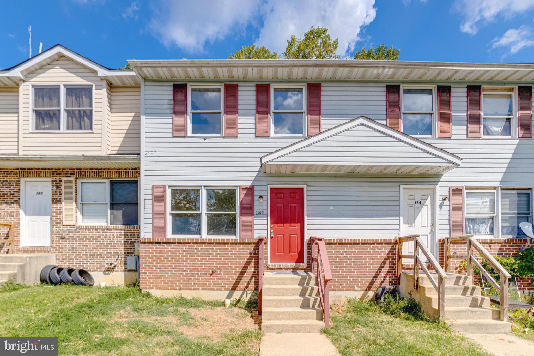 Charming townhouse with vibrant curb appeal.