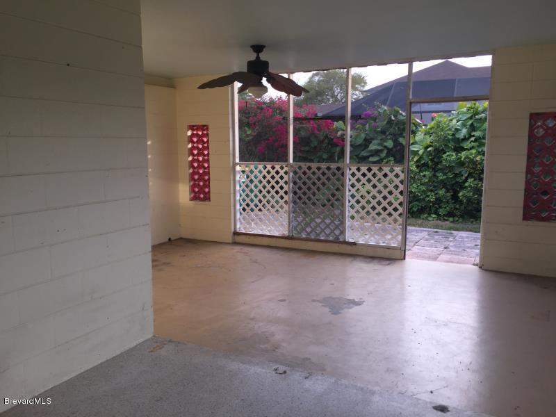 1081 Bali Road Cocoa Beach, FL 32931 - Photo 13 of 17 a view of a glass door with a bench in patio