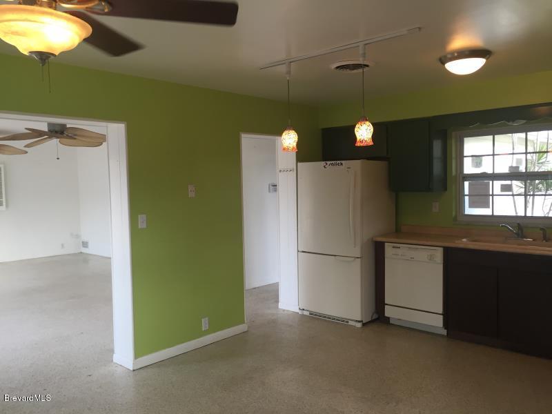 1081 Bali Road Cocoa Beach, FL 32931 - Photo 7 of 17 a kitchen with a refrigerator and a stove