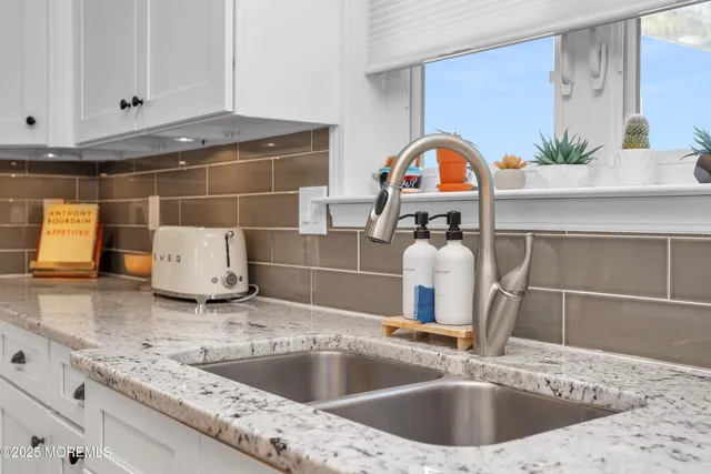 a kitchen with a sink and a stove top oven