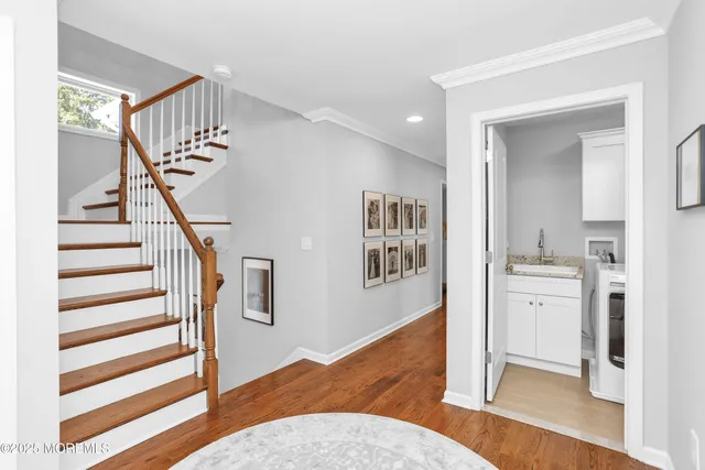 a view of entryway and hall with wooden floor