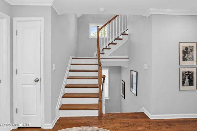 a view of entryway and hall with wooden floor