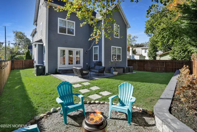 a view of a chair and table in backyard of the house
