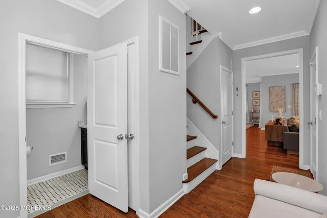 a view of entryway and hall with wooden floor