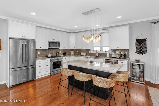 a kitchen with refrigerator cabinets dining table and chairs
