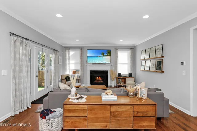a living room with furniture a fireplace with wooden floor