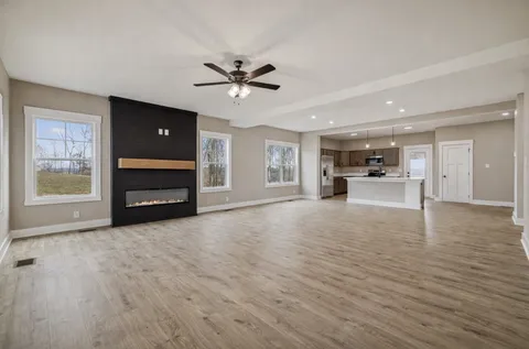 a view of living room with furniture and a ceiling fan
