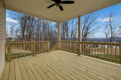 a view of deck with wooden floor and fence