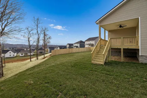 a view of a house with a backyard