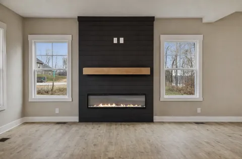 a living room with a fireplace and a window