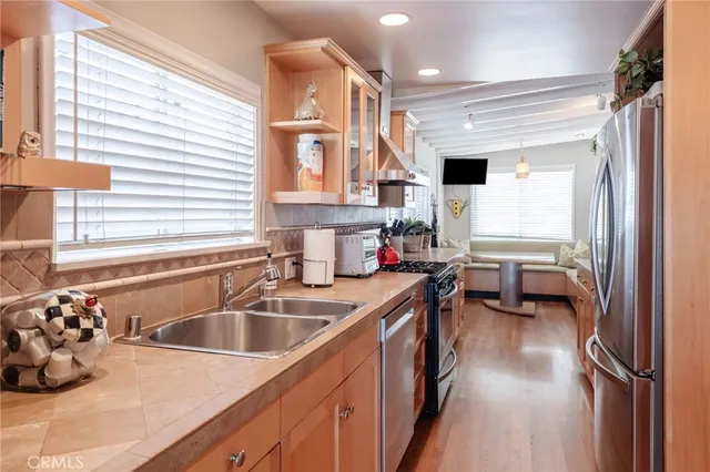 a kitchen with a sink appliances and cabinets