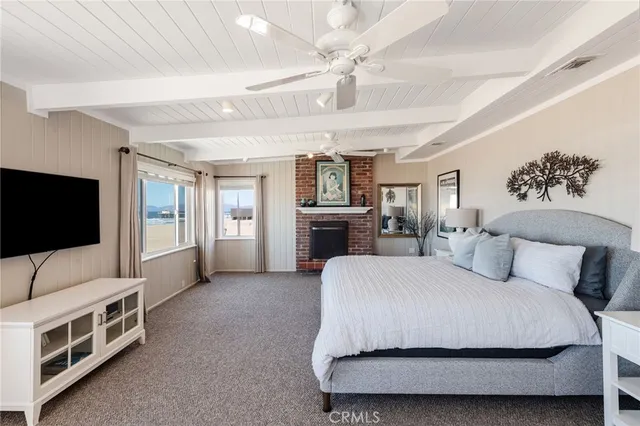 a spacious bedroom with a bed and a flat screen television