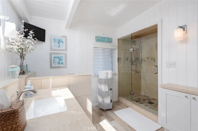 a bathroom with a tub shower and sink