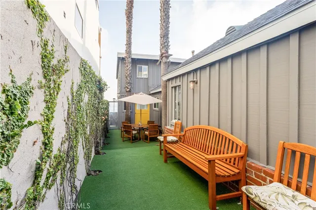 a backyard of a house with table and chairs