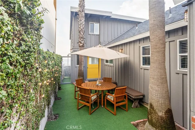 a backyard of a house with table and chairs