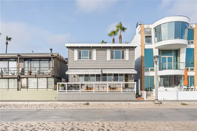 a front view of a building with a garden and plants