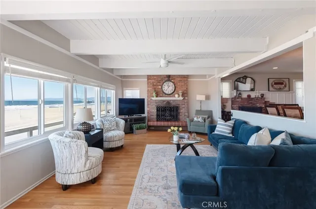 a living room with fireplace furniture and a large window
