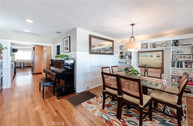 a dining room with furniture and wooden floor