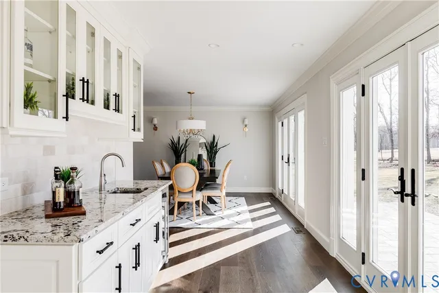 a kitchen with stainless steel appliances granite countertop a sink and a stove