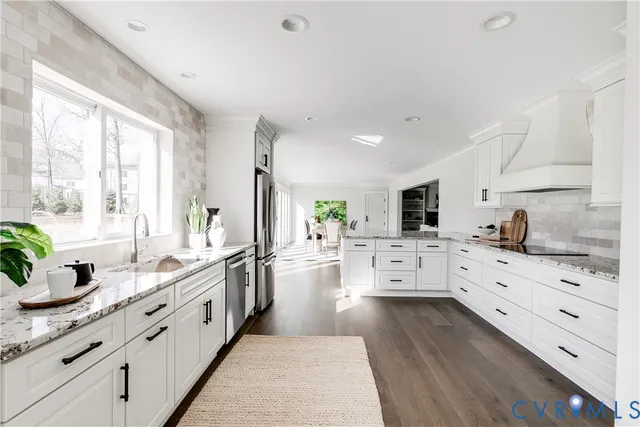 a large white kitchen with cabinets