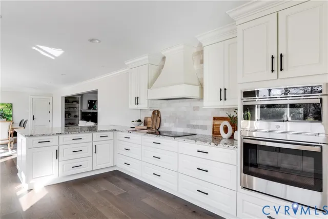 a kitchen with stainless steel appliances white cabinets and white appliances