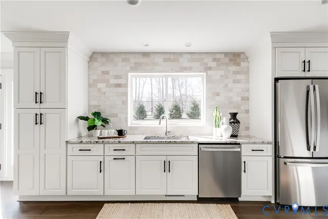 a kitchen with white cabinets and white appliances